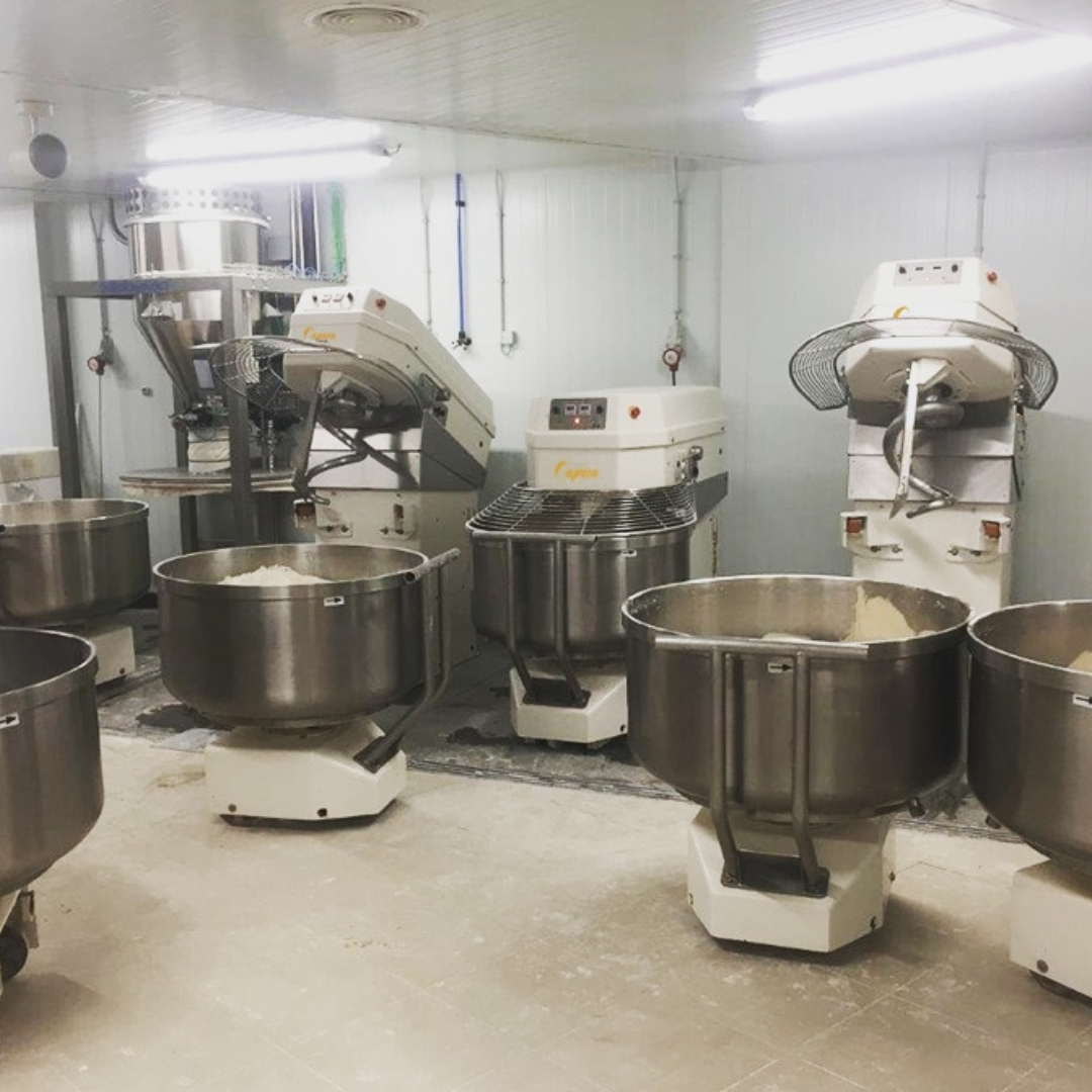 Caprea mixer bowls filled with dough on the bakery floor